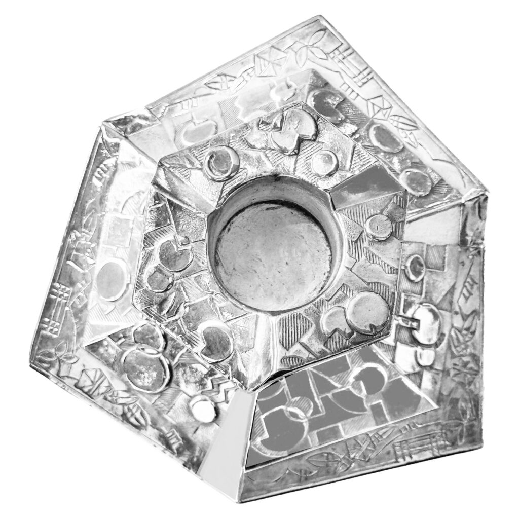 Ornate silver candle holder, top view.